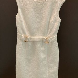Women’s white dress with gold-colored rings